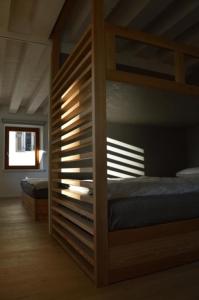 a bedroom with two bunk beds and a window at Dimora Sannicolò - Talento in Rovereto