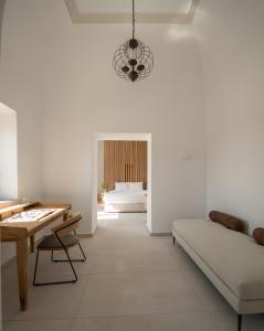 VILLA DI CAPO - Santorini Old Winery Luxury Villas في أكروتيري: غرفة معيشة مع أريكة وطاولة