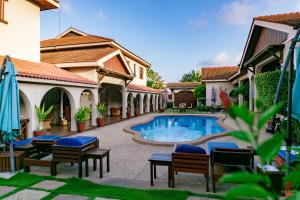 a courtyard with a swimming pool in a house at Mahogany Lodge, Cantonments in Accra