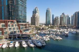 a group of boats docked in a harbor in a city at Frank Porter - Cayan Tower in Dubai