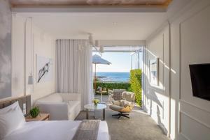 a hotel room with a bed and a view of the ocean at The Marly Boutique Hotel in Cape Town