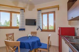 a kitchen with a table with a blue table cloth at Apartment Lino in Premantura