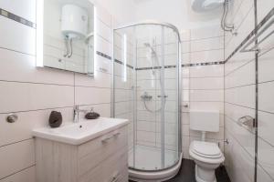 a bathroom with a shower and a toilet and a sink at Apartment Lino in Premantura +20 photos