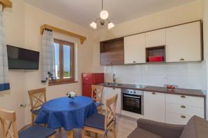 a kitchen with a table with a blue table cloth at Apartment Lino in Premantura