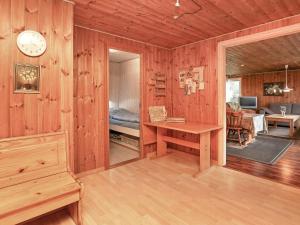 a room with wooden walls and a clock on the wall at 10 person holiday home in Løkken-By Traum in Løkken