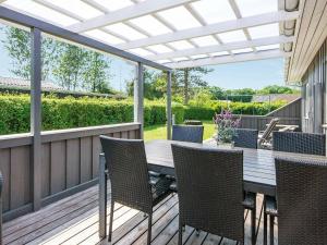 a patio with a table and chairs on a deck at 6 person holiday home in Haderslev in Diernæs