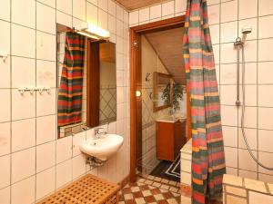 a bathroom with a sink and a mirror and a toilet at 10 person holiday home in Løkken-By Traum in Løkken +14 photos