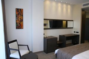 Postel nebo postele na pokoji v ubytování Hotel Scapino