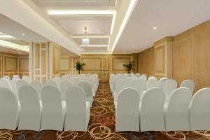 a room with rows of chairs in a room at Lemon Tree Premier, Delhi Airport in New Delhi +69 photos