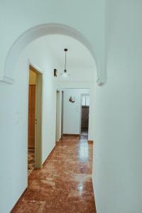 an empty hallway with an archway in a house at villa62rodos in Kremasti