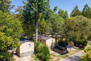 an aerial view of a house with a truck parked in front of it at Camping du Pont d'Avignon in Avignon