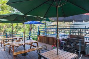 a group of tables with umbrellas on a deck at PULI GuanPu Fallsview Stay House in Puli