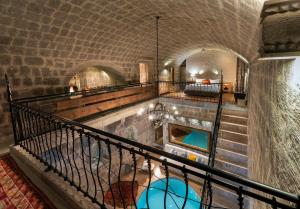 a staircase in a building with a swimming pool at Argos in Cappadocia in Uçhisar