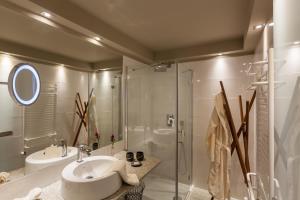 a bathroom with a sink and a shower at Arlberg Stuben - das kleine, feine Hotel in Stuben am Arlberg