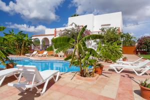 a resort with a swimming pool and lounge chairs at Can Ramos in Ses Fontanelles