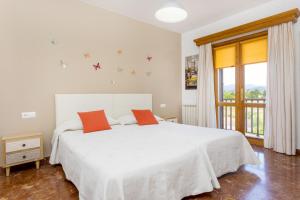 a bedroom with a large white bed and a window at Huerta in San Antonio +49 photos