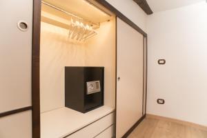 a walk in closet with a tv and a mirror at Casa Napoletana - Spaccanapoli in Naples