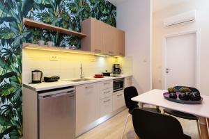 a kitchen with a sink and a table with chairs at Iliana Apartments in Falasarna