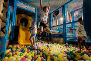 a group of children jumping in a ball pit at Pinetina Mare Baby Family Hotel in Cervia