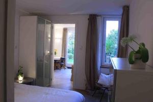 a bedroom with a bed and a desk and a window at Arnhem Studios in Arnhem