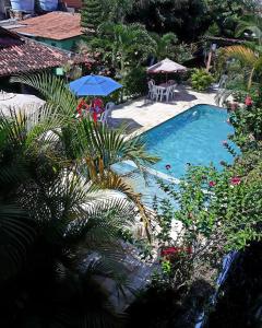 an overhead view of a swimming pool with umbrellas and plants at Pousada do Gordo in Bonito