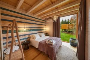 a bedroom with a bed and a large window at Vila Sen Vento in O Pino 