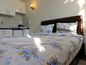 a bedroom with a bed with a blue and white comforter at Old City Pansiyon in Istanbul