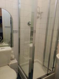 a bathroom with a shower with a toilet and a sink at Strides Hotel in Blackpool