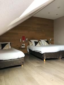 A bed or beds in a room at Logis Hôtel-Restaurant Les Loges
