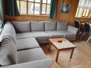 a living room filled with furniture and a couch at Guesthouse Stöng and Cottages in Stöng
