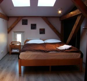 a bedroom with a large bed in a attic at Pentagos Centrum in Poznań