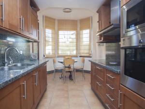 a kitchen with a sink and a table with chairs at GRAN BAHIA de Marbella in Marbella
