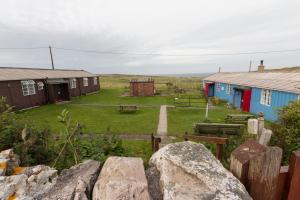 a group of houses and a yard with rocks at Durness Youth Hostel in Durness