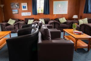 a living room with couches and chairs and a table at Durness Youth Hostel in Durness