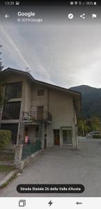 a building with a balcony on the side of it at Casa Monte Bianco in Morgex