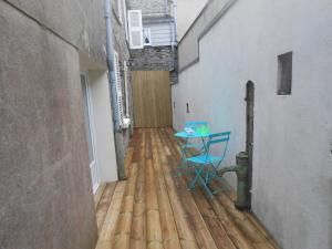 una camera con un tavolo e una sedia su un pavimento in legno di Petit nid douillet à Port-bail a Portbail