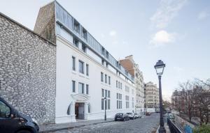 a white building on the side of a street at Odalys City Paris Montmartre in Paris