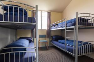 a room with two bunk beds and a chair at Durness Youth Hostel in Durness
