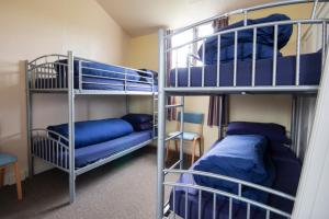 a room with two bunk beds and a bed at Durness Youth Hostel in Durness