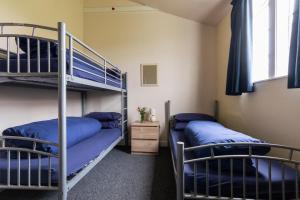 a room with two bunk beds and a window at Durness Youth Hostel in Durness
