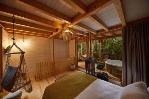 a bedroom with a bed and a tub in a room at HolaCamp Camino in O Pino  +213 photos