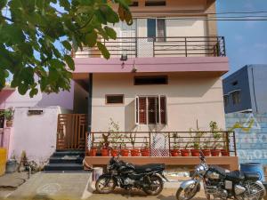 two motorcycles parked in front of a building at Vijayanagara Home Stay in Hampi