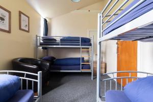 a dorm room with bunk beds and a couch at Durness Youth Hostel in Durness