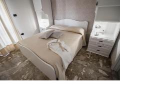 ein kleines Schlafzimmer mit einem Bett und einem Nachttisch in der Unterkunft B&B ARENA in Pompei