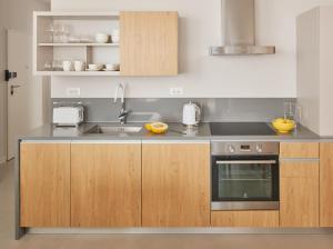 a kitchen with a sink and a stove at Eol Apartments Split Žnjan Beach in Split +67 photos