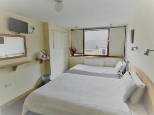 Säng eller sängar i ett rum på Hounslow Central Hotel