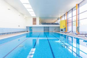 a swimming pool with a blue floor and blue walls at Horizons Accommodation in London