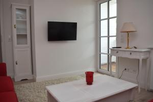a living room with a tv on a wall at Ferienwohnung-Clarissa in Morsum