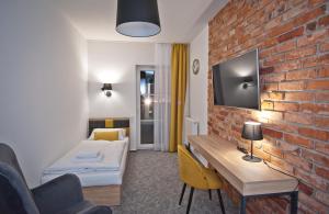 Łóżko lub łóżka w pokoju w obiekcie ApartHOTEL Gostyń