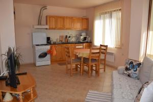 a kitchen and living room with a table and chairs at Panorama Stoykite Yana apartment in Pamporovo
